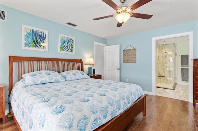 bedroom featuring dark hardwood / wood-style flooring, ensuite bath, and ceiling fan