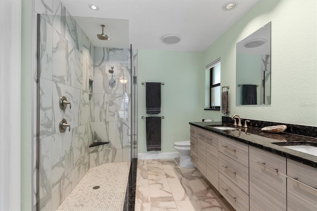 bathroom with vanity, toilet, and a shower with shower door