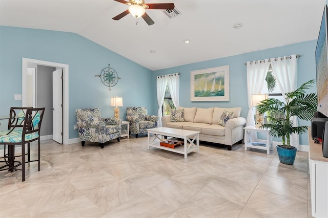 living room with ceiling fan, a wealth of natural light, and vaulted ceiling