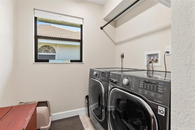 clothes washing area with washing machine and clothes dryer