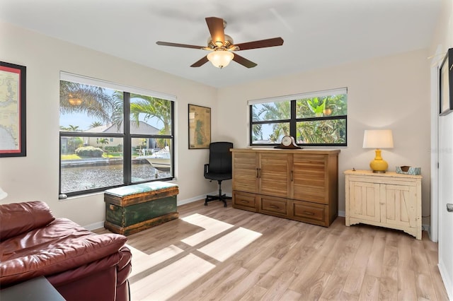 living area with light hardwood / wood-style floors and ceiling fan