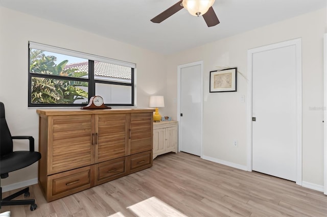 home office with ceiling fan and light hardwood / wood-style floors