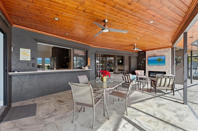 view of patio with a tile fireplace and ceiling fan