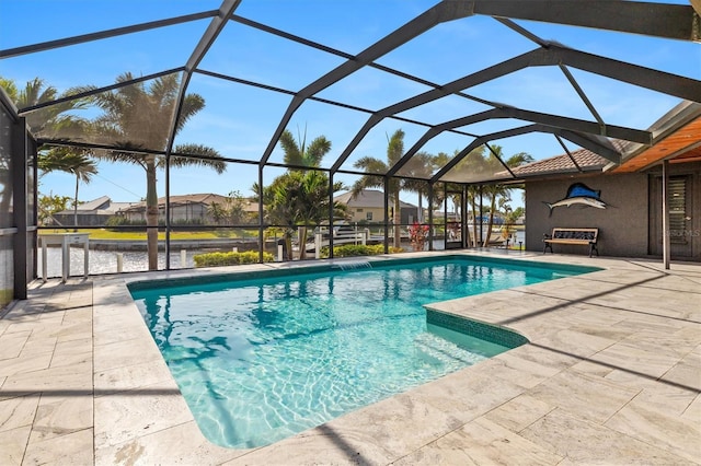 view of swimming pool featuring a patio area and a lanai