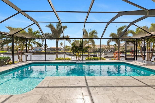 view of swimming pool featuring a water view, a patio area, and a lanai