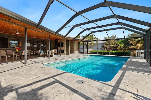 view of pool featuring a lanai, a patio area, and ceiling fan