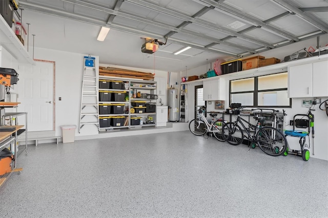 garage with electric water heater and a garage door opener