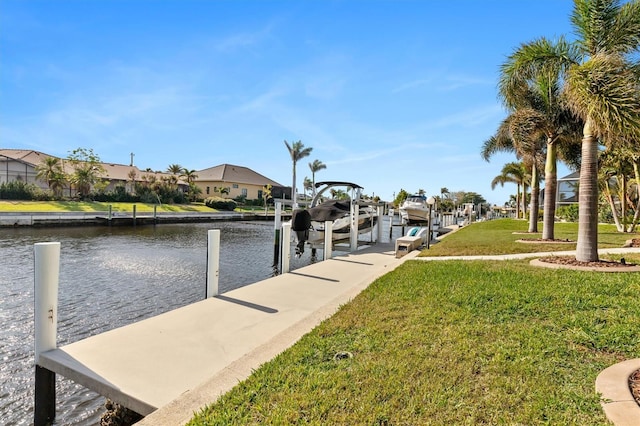 view of dock with a water view and a yard