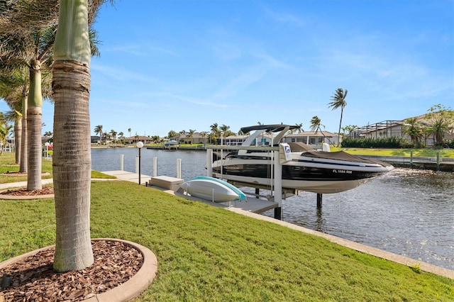 view of dock featuring a lawn and a water view