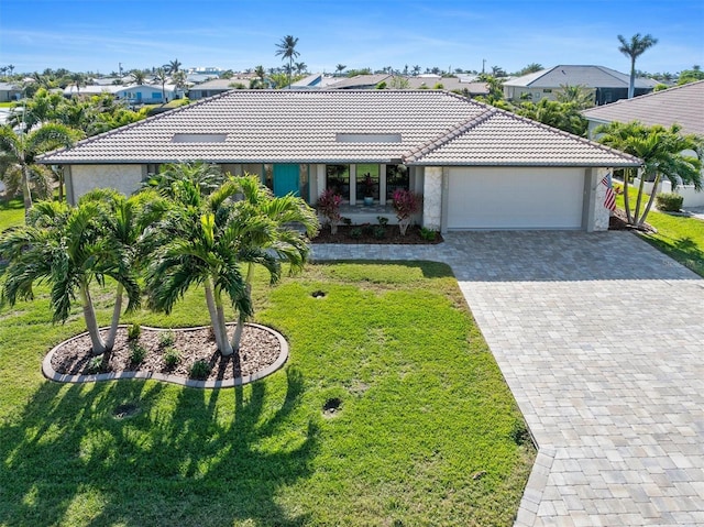 view of front of house with a garage and a front lawn