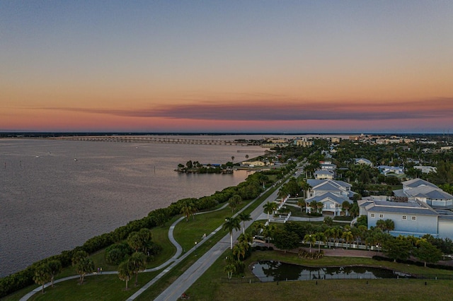 aerial view at dusk with a water view