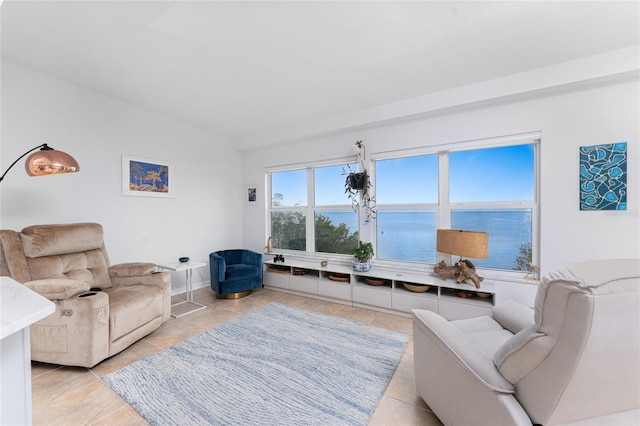 living room featuring a water view and light tile patterned floors