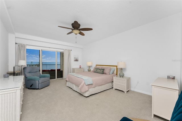 carpeted bedroom featuring ceiling fan and access to outside