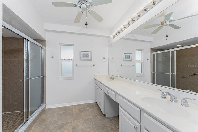 bathroom with ceiling fan, a shower with shower door, and vanity