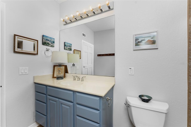 bathroom featuring toilet and vanity