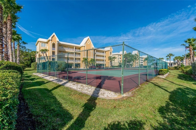 view of sport court featuring a lawn