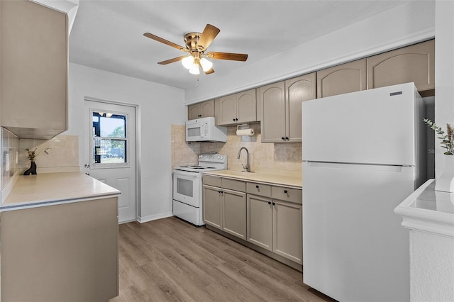 kitchen featuring white appliances, sink, ceiling fan, tasteful backsplash, and light hardwood / wood-style floors