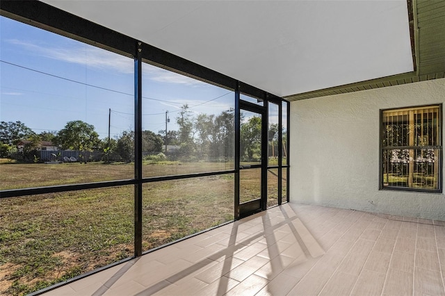 unfurnished sunroom featuring plenty of natural light