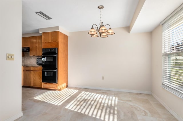 kitchen with tasteful backsplash, ventilation hood, black double oven, pendant lighting, and a chandelier