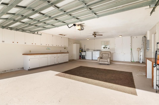 garage featuring a garage door opener, washer and clothes dryer, and ceiling fan