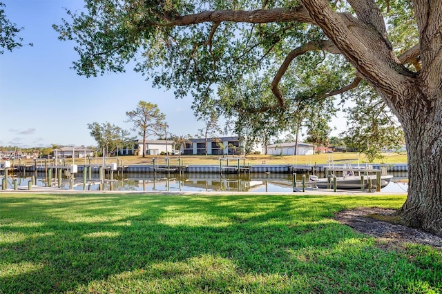 view of dock featuring a yard and a water view