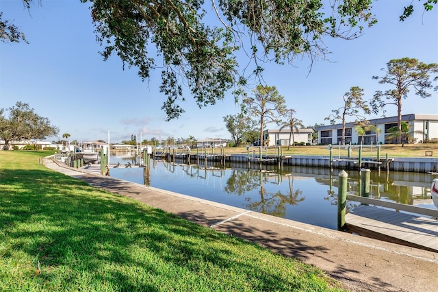 view of dock featuring a yard and a water view