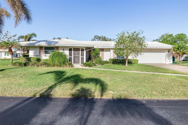 ranch-style home with a front lawn and a garage