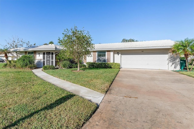 ranch-style home featuring a garage and a front lawn