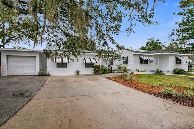 single story home with a garage and a front yard