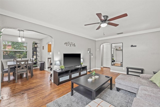 living room featuring hardwood / wood-style floors and ceiling fan