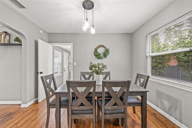 dining area with wood-type flooring