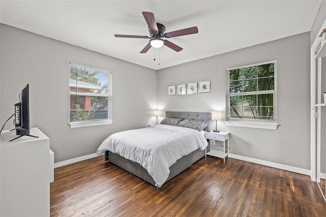 bedroom with dark hardwood / wood-style floors and ceiling fan