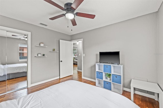 bedroom with wood-type flooring, a closet, and ceiling fan