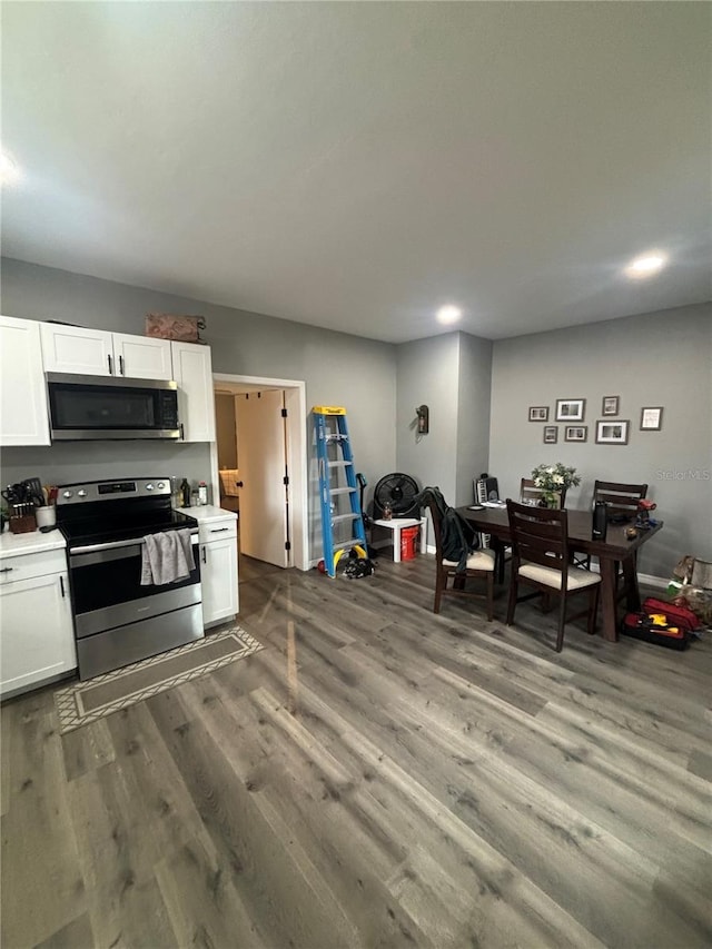 kitchen with white cabinetry, wood-type flooring, and appliances with stainless steel finishes