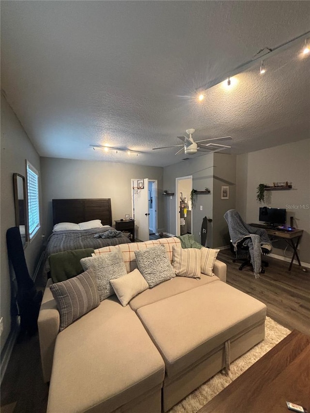 bedroom with hardwood / wood-style flooring, ceiling fan, and a textured ceiling