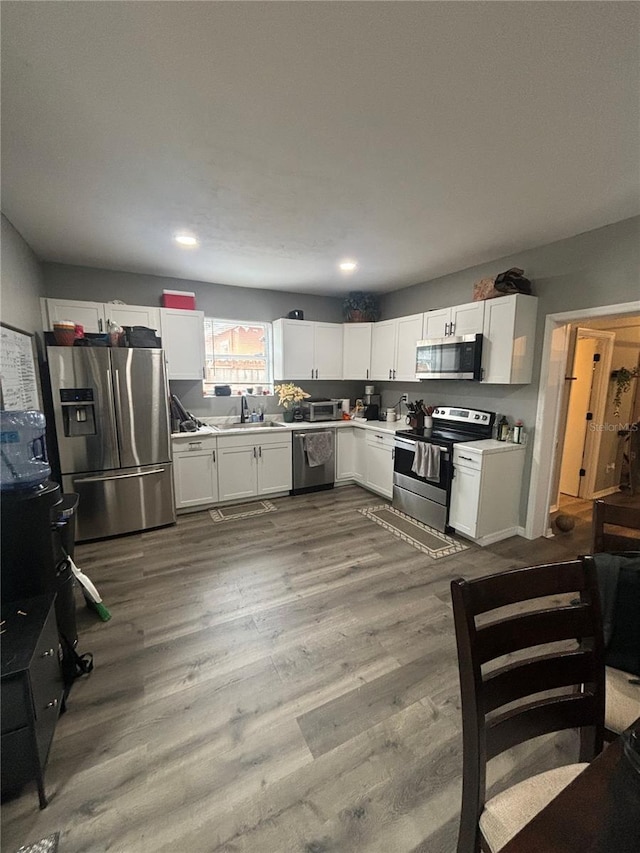 kitchen with white cabinetry, appliances with stainless steel finishes, and sink