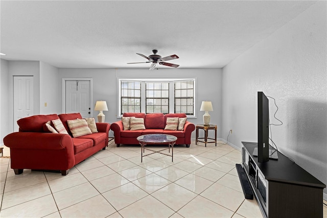 tiled living room with ceiling fan