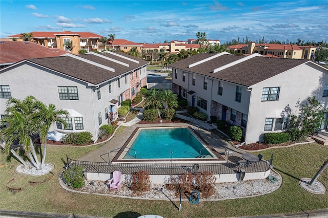 view of swimming pool featuring a yard and a patio