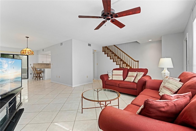 living room with ceiling fan and light tile patterned flooring