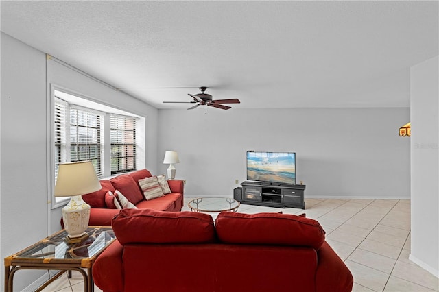 tiled living room with a textured ceiling and ceiling fan