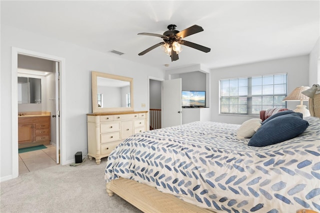 carpeted bedroom with connected bathroom and ceiling fan