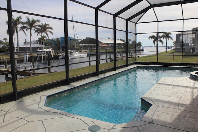 view of pool featuring a water view, glass enclosure, a boat dock, and a patio