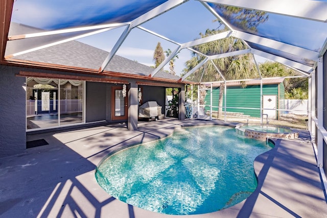 view of pool with glass enclosure, a patio area, and an in ground hot tub