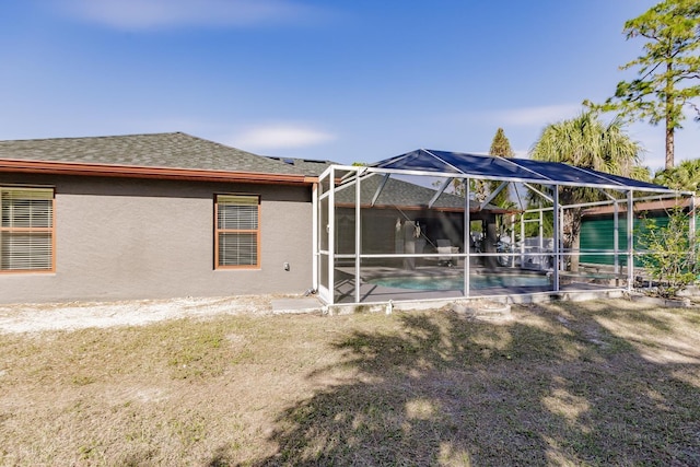 rear view of property featuring glass enclosure