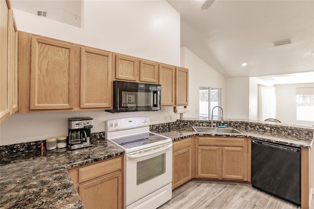 kitchen featuring sink, high vaulted ceiling, dark stone countertops, light hardwood / wood-style floors, and black appliances