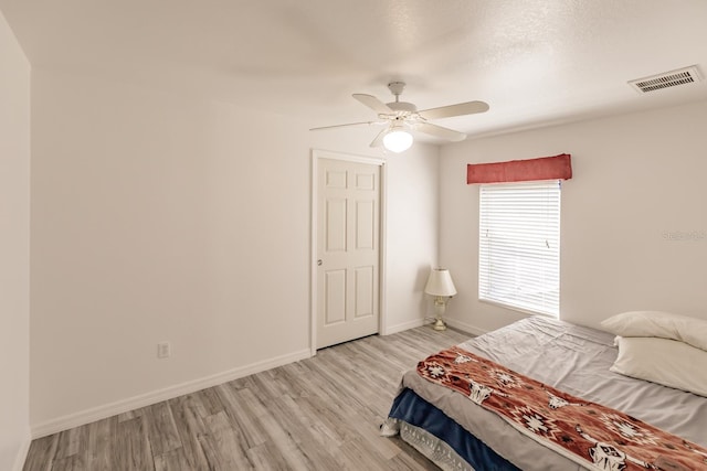 bedroom featuring light hardwood / wood-style floors and ceiling fan