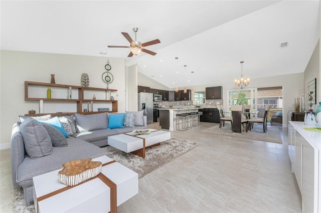 living room featuring ceiling fan with notable chandelier and lofted ceiling