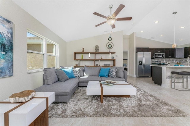 living room with ceiling fan, lofted ceiling, and sink