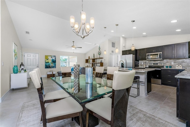 dining room featuring ceiling fan with notable chandelier and lofted ceiling