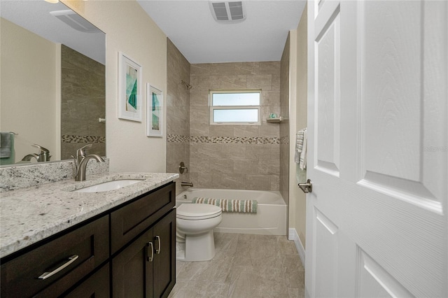 full bathroom with vanity, tiled shower / bath combo, and toilet